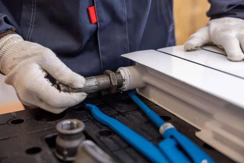 Loodgieter monteert een radiatorleiding